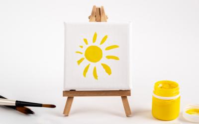 Paint, paintbrushes, canvas and easel