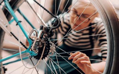 Woman examining a bicycle tire