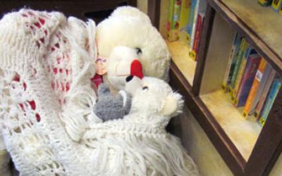 Stuffed animals tucked in a blanket