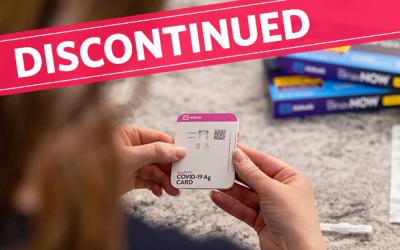 DISCONTINUED banner over woman's hands holding test kit
