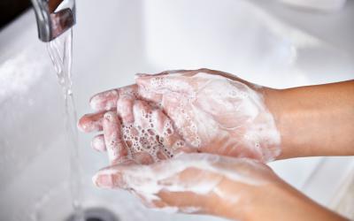 Person washing hands under running water