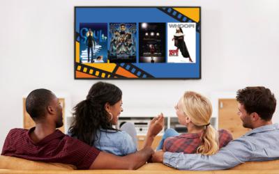 Two couples sit on couch with TV displaying Black Joy Film Series promotion