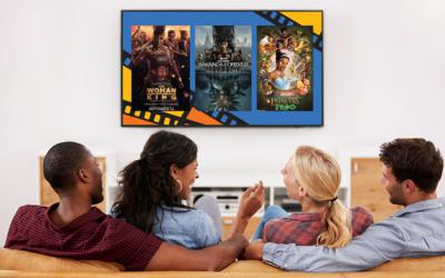 Two couples sit on couch with TV displaying Black Joy Film Series promotion