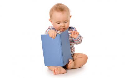 Baby playing with book