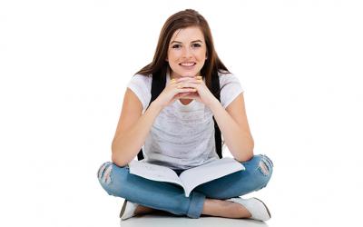 Teenager sitting with a book in her lap