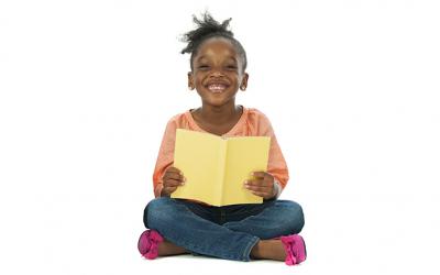 Girl holding a book and smiling