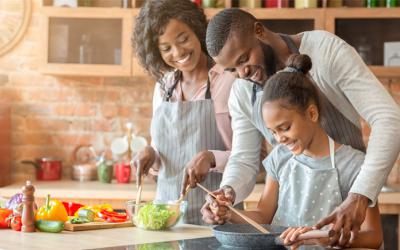 Two adults and a child preparing a meal