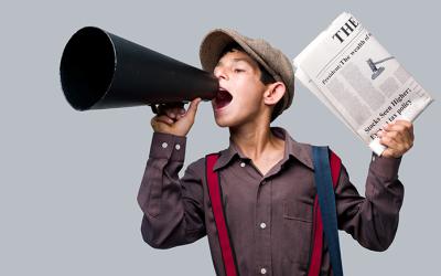 Child in a newsboy costume holding a megaphone and newspaper