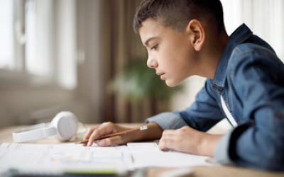 Student at desk reading schoolwork