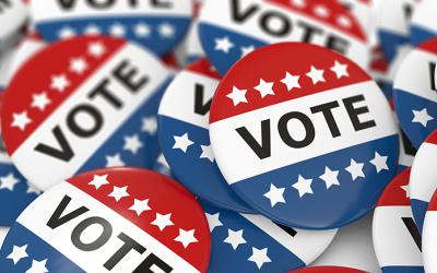 Red, white and blue buttons with the word Vote